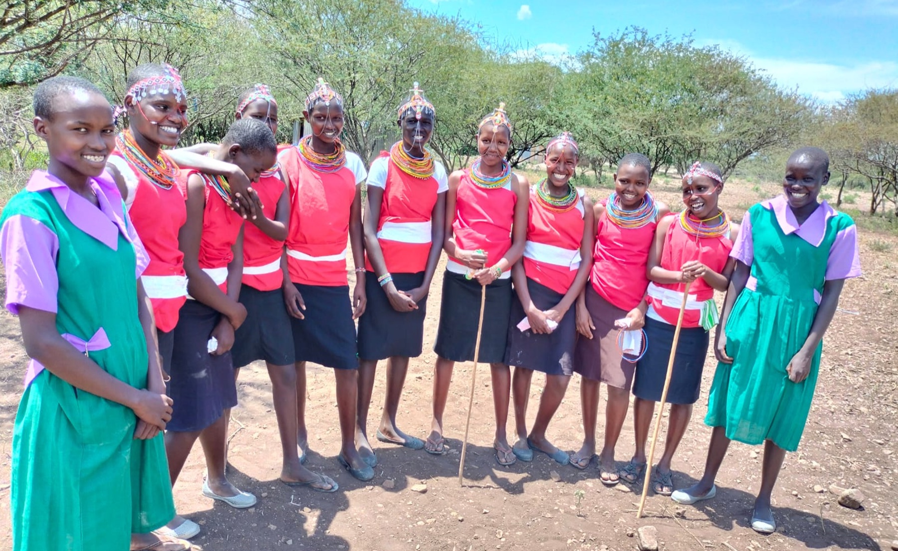 Young women in colourful traditional dress and beadwork at a community gathering in Kenya